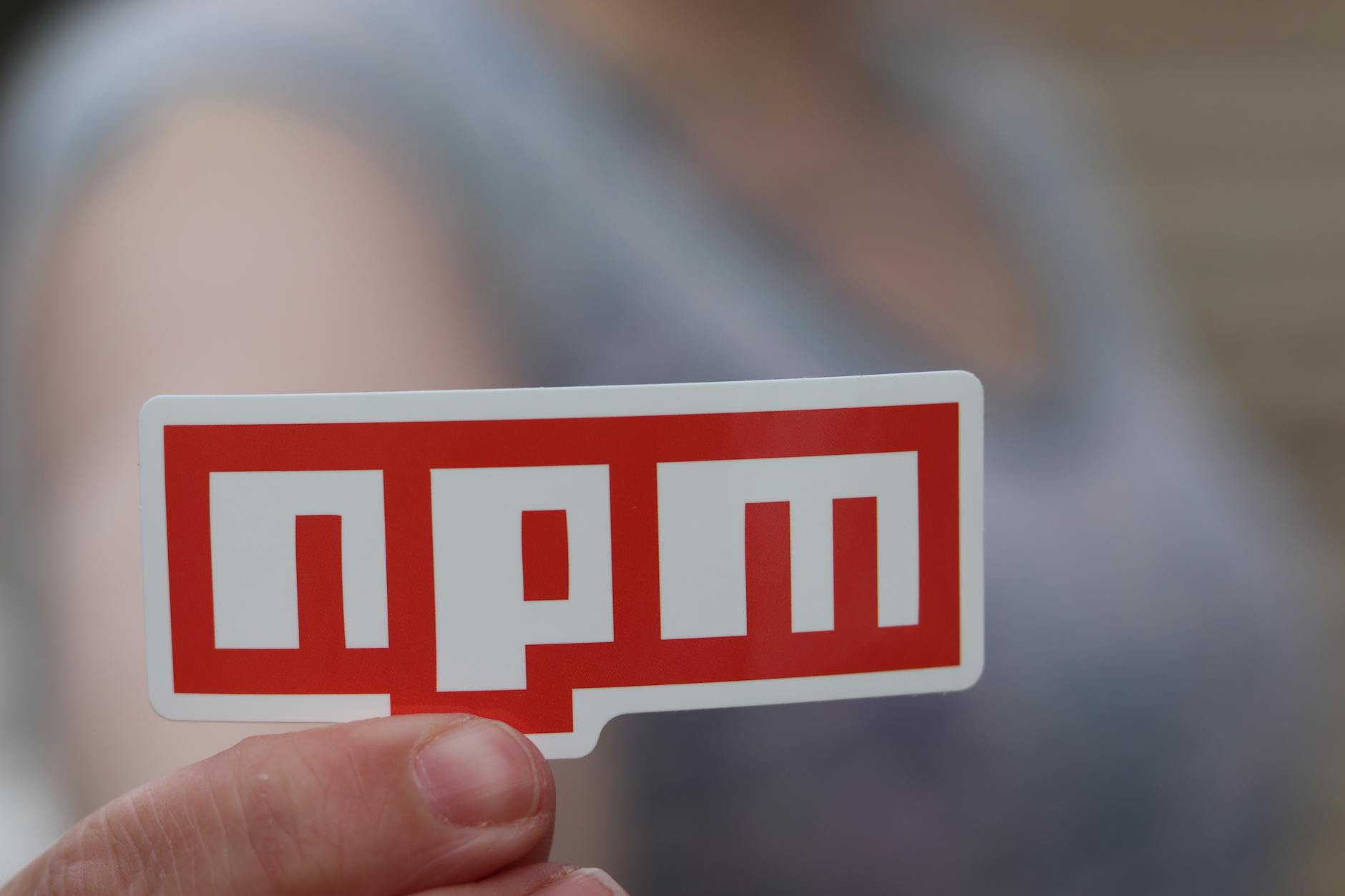 npm sticker on a laptop representing software version control and developer workflow checkpoints