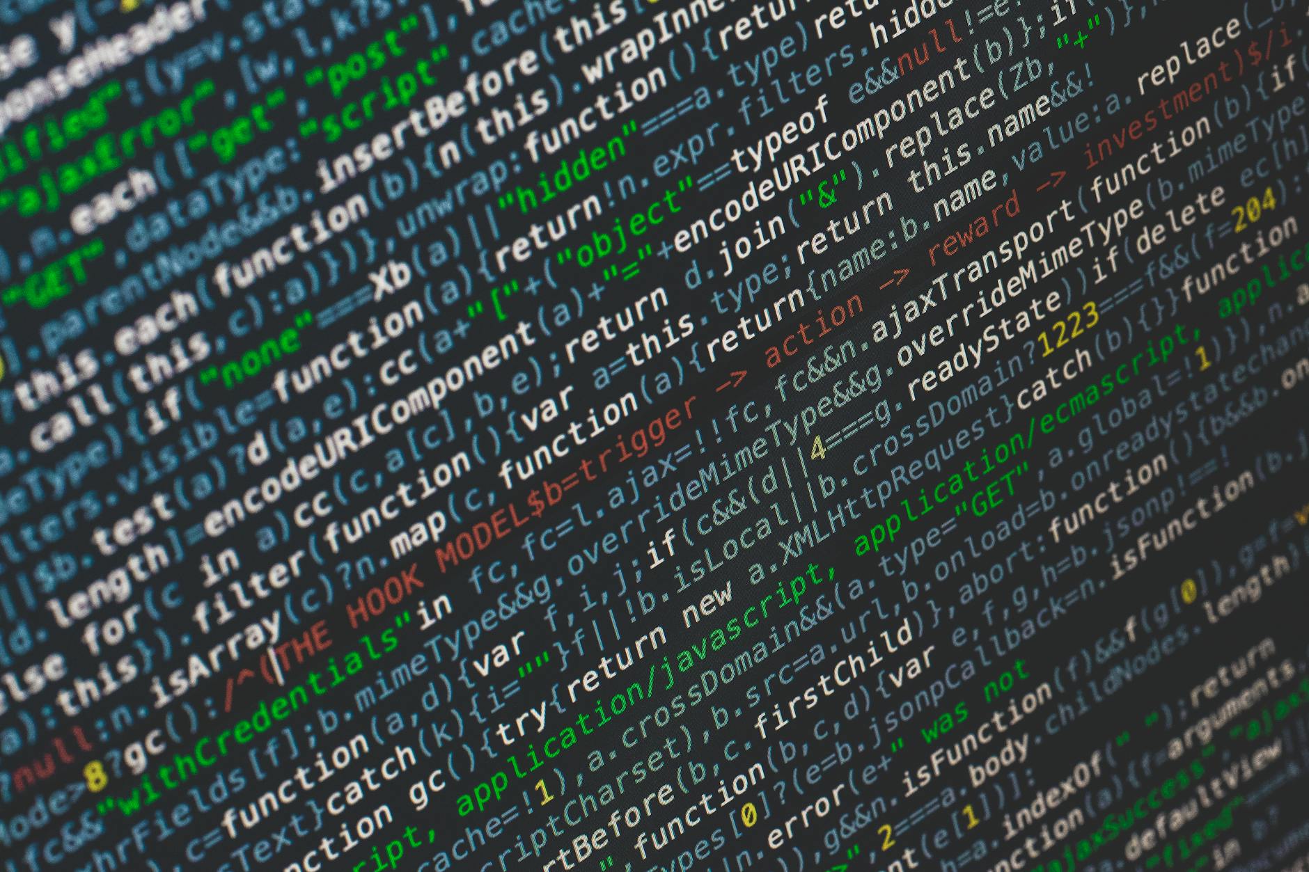 JavaScript code on a computer screen viewed at an angle showing programming syntax